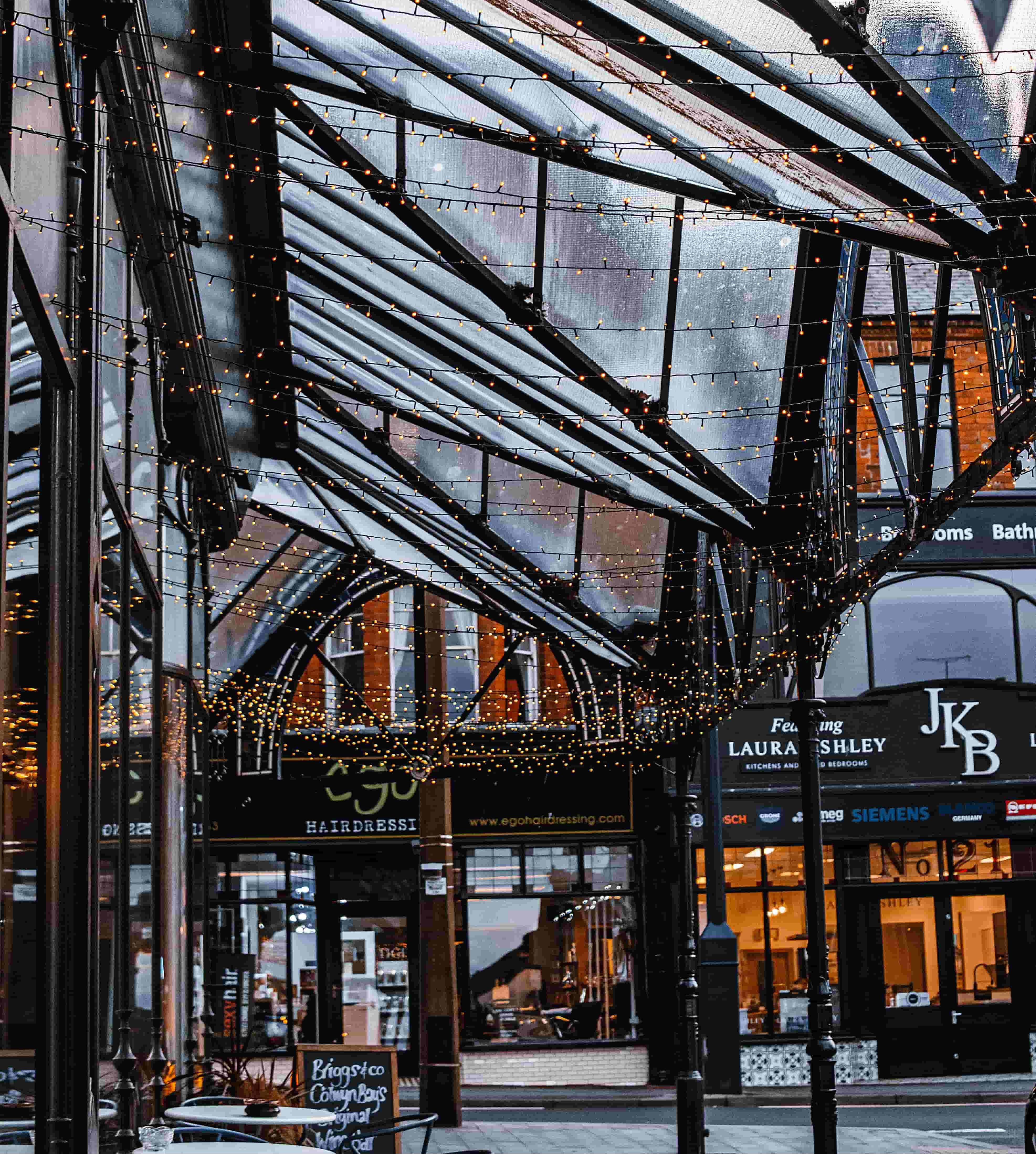 Covered shopping arcade in Harrogate town centre, decorated with bunting and string lights